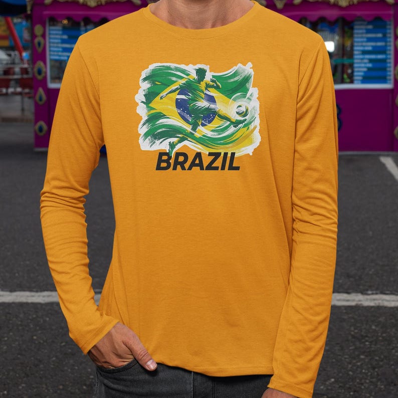 A person wearing a yellow long-sleeved shirt with a graphic of a soccer player and the word "BRAZIL" printed on it.