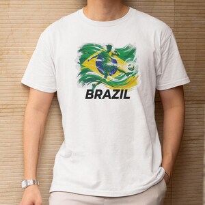 A white t-shirt with a graphic design of the Brazilian flag and the word "BRAZIL" printed on it.
