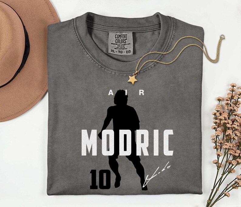 a gray t-shirt with a silhouette of a person and the text "AIR MODRIC 10" printed on it.
