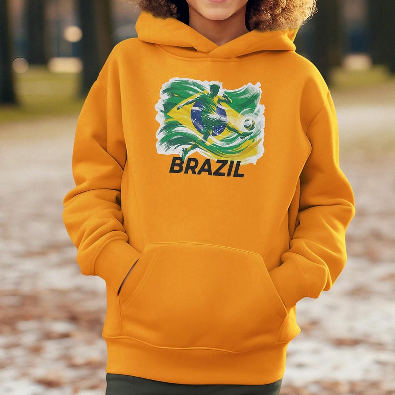 A person wearing a yellow hoodie with a graphic of the Brazilian flag printed on it.