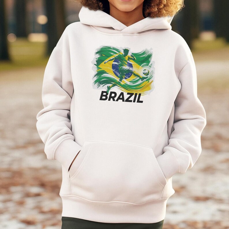 A person wearing a white hoodie with a graphic of a soccer player and the word "BRAZIL" printed on it.