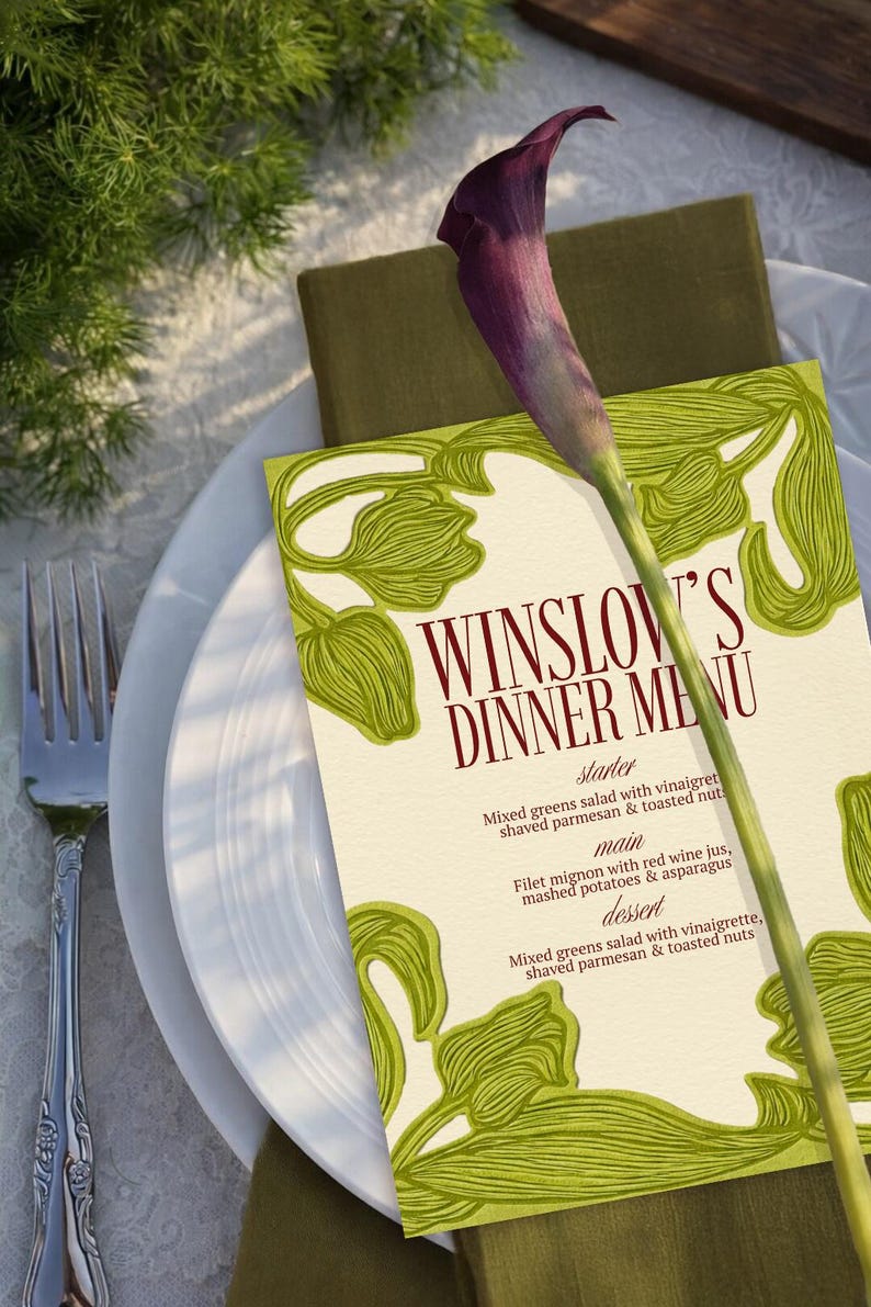 May include: A dinner menu titled "Winslow's Dinner Menu" with a green floral design, a purple calla lily, and a white plate. The menu lists a starter, main course, and dessert. The menu is on a white tablecloth.