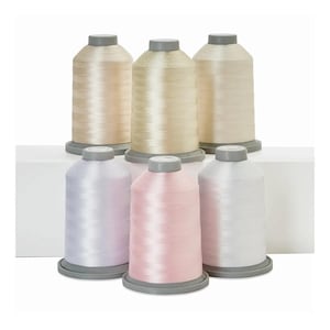 May include: Six spools of thread in various shades of white, cream, and pink. The spools are arranged in two rows of three.