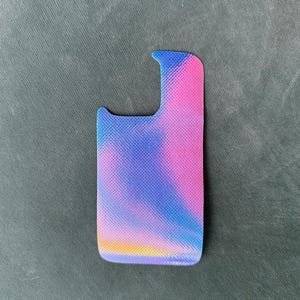 May include: A colorful phone case with a vibrant design. The case features a gradient of pink, blue, and yellow hues, creating a visually appealing aesthetic. The case is designed to fit a phone and has a textured surface.