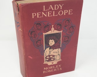Edición antigua de tapa dura roja de Lady Penelope, autor Morley Roberts, publicada en 1905.