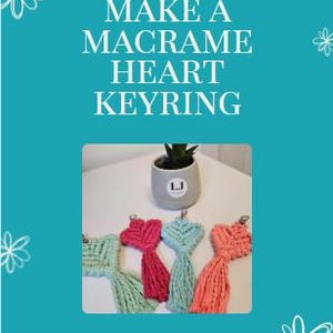 May include: A teal background with white text reading "HOW TO MAKE A MACRAME HEART KEYRING." The image shows four macrame heart keyrings in shades of green, pink, and coral. A small potted plant sits on a white surface.