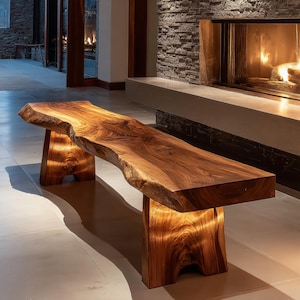 Può includere: Una panca in legno realizzata a mano con un design a bordo vivo. La panca è realizzata in un legno marrone scuro ricco e presenta due robuste gambe illuminate. La panca è lunga circa 183 cm.