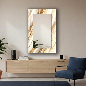 Peut inclure: Un miroir mural rectangulaire avec un motif semblable &agrave; du marbre dans les tons de blanc, d'or et de marron. Le miroir a une forme rectangulaire avec un miroir rectangulaire plus petit au centre. D&eacute;coration int&eacute;rieure.
