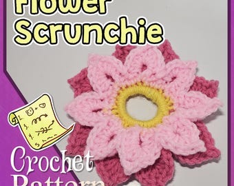 May include: A crochet flower scrunchie pattern with instructions. The flower is pink and yellow and has a center hole for a hair elastic.