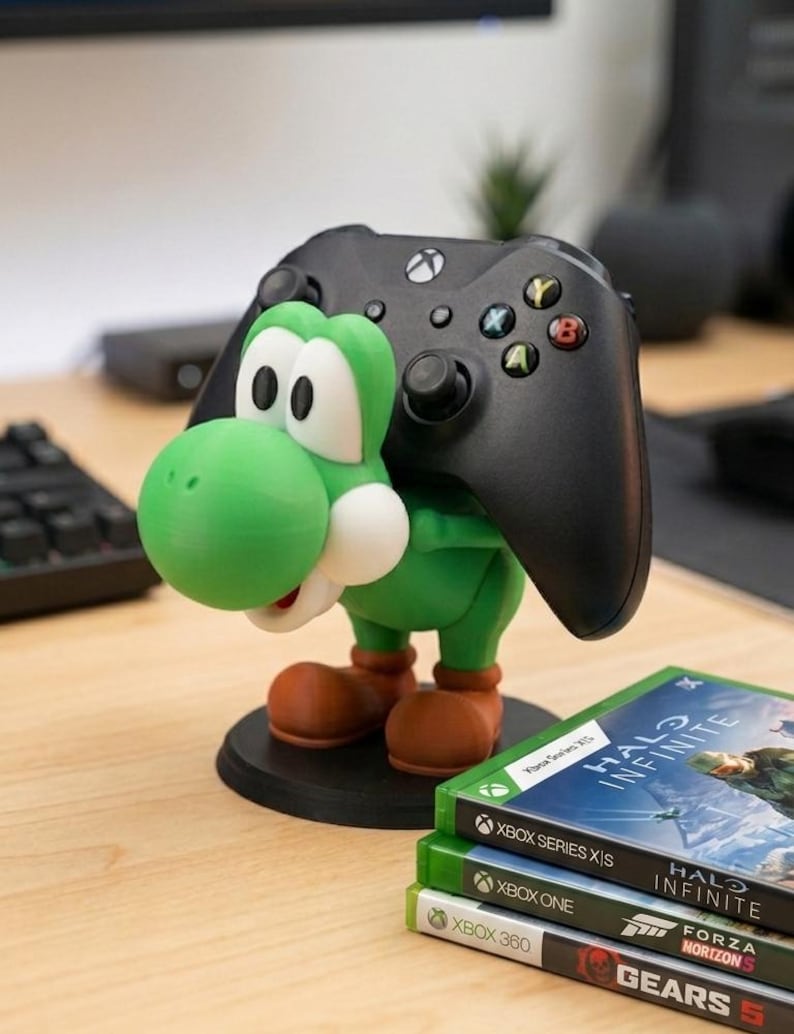Soporte universal para mandos de Nintendo Switch, PlayStation, XBOX o PC inspirado en Yoshi, el personaje de Mario Bros, ideal para regalo de cumpleaños original tanto para niños como para mayores gamers.