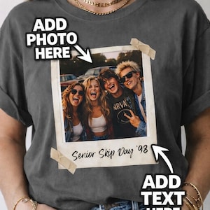May include: Dark gray t-shirt featuring a vintage-style photo of four smiling people. The photo is taped to the shirt with beige tape and has the text "Senior Skip Day '98". The shirt has the text "Add Photo Here" and "Add Text Here".