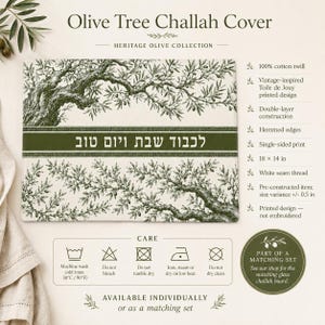 May include: A rectangular 18 by 14 inch cotton twill challah cover featuring a green olive tree branch print on a white background. A central dark green horizontal band displays the Hebrew text "לכבוד שבת ויום טוב" in white lettering.