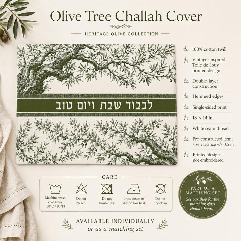 May include: A rectangular 18 by 14 inch cotton twill challah cover featuring a green olive tree branch print on a white background. A central dark green horizontal band displays the Hebrew text "לכבוד שבת ויום טוב" in white lettering.