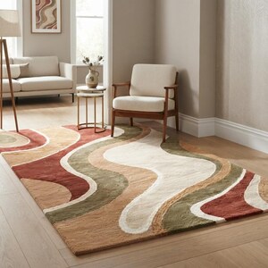 May include: A rectangular area rug featuring a repeating pattern of wavy, organic bands in shades of terracotta, olive green, cream, and tan. The rug has a soft, textured pile and covers a portion of the light-colored wooden floor in the room.