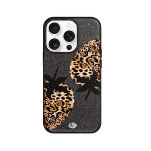 May include: Black glitter phone case with a leopard print strawberry design. The strawberries have black leaves and are embellished with rhinestones. The case has a black border and a camera cutout.