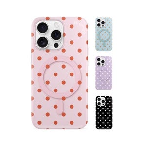 May include: Pink phone case with a polka dot pattern and a circular magnetic attachment. Additional cases in light blue, lavender, and black with similar designs are also shown. The cases are designed to fit a smartphone.