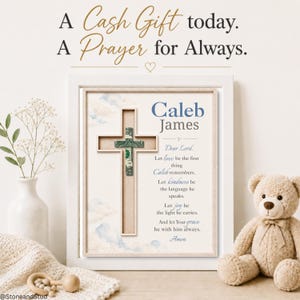 May include: A framed wall art piece featuring a wooden cross with a banknote folded into a cross shape at the centre. The print includes the name Caleb James and a prayer in blue and black text, set against a background of soft clouds.