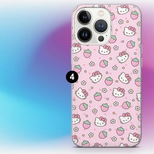 May include: A pink phone case featuring a repeating pattern of Hello Kitty faces, strawberries, and flowers. The case has a clear border and a camera cutout. The background is a gradient of blue, purple, and pink.