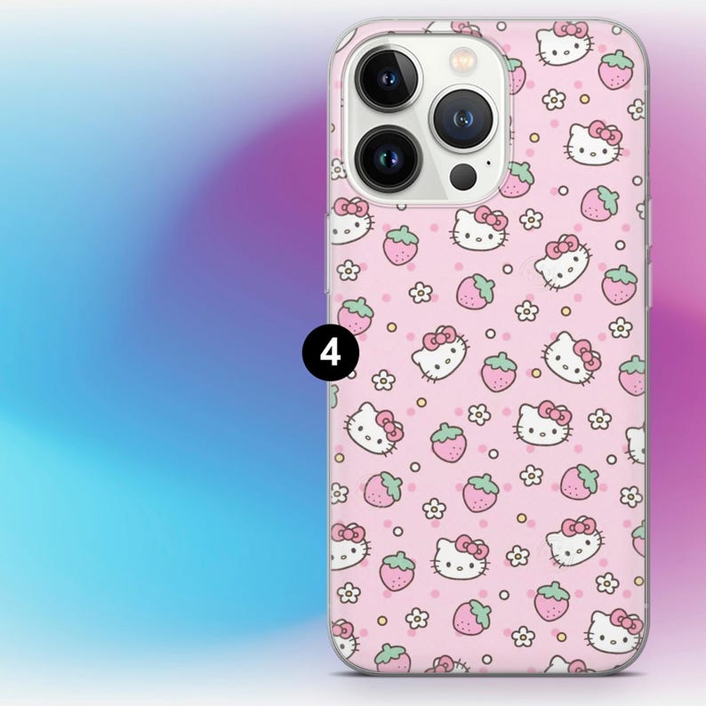 May include: A pink phone case featuring a repeating pattern of Hello Kitty faces, strawberries, and flowers. The case has a clear border and a camera cutout. The background is a gradient of blue, purple, and pink.