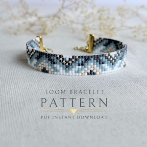May include: A beaded loom bracelet with a geometric pattern in shades of white, blue, black, and gold. The bracelet has gold-colored clasps. The image also includes the text "LOOM BRACELET PATTERN PDF INSTANT DOWNLOAD."
