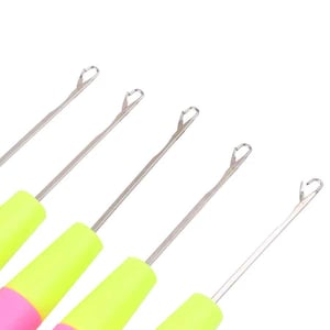 May include: Close-up of several crochet hooks with silver metal shafts and neon green and pink handles. The hooks are angled towards the upper right corner against a white background. The hooks are designed for various crochet projects.