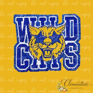 May include: A glittery blue and yellow embroidered patch featuring the text WILDCATS in a bold block font. The design includes a central yellow feline head with blue accents, all outlined in a thick, sparkling blue border on a yellow background.