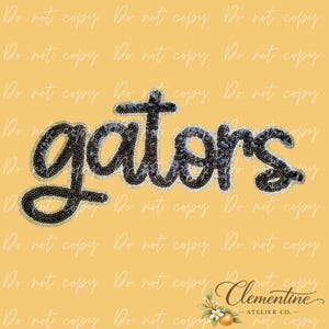 May include: A patch featuring the word gators written in a cursive script. The letters are constructed from dark, shimmering sequins with a gold-toned border. The design is set against a solid yellow background with a watermark pattern.