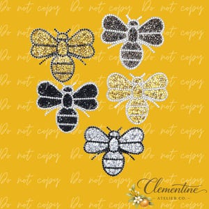 May include: Five bee-shaped iron-on transfers decorated with sparkling rhinestones. The collection includes two gold-toned bees, two black-toned bees, and one silver-toned bee, all featuring detailed wings and striped bodies on a yellow background.