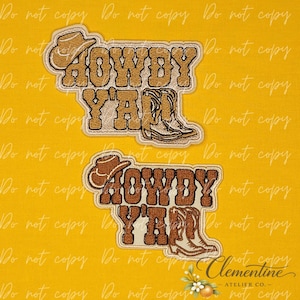 May include: Two embroidered patches featuring the text "HOWDY Y'ALL" in a bold, western-style font. Each patch includes a small cowboy hat icon and a pair of cowboy boots. One patch is in shades of tan and brown, while the other is dark brown.
