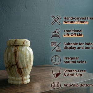 May include: A cylindrical urn crafted from light green natural stone with brown veining and a matching lift-off lid. Text on the right lists features: Hand-carved from Natural Stone, Traditional Lift-Off Lid, Suitable for indoor display and burial, Irregular natural veins, Scratch-Free & Anti-Slip, and Anti-Slip Bottom.