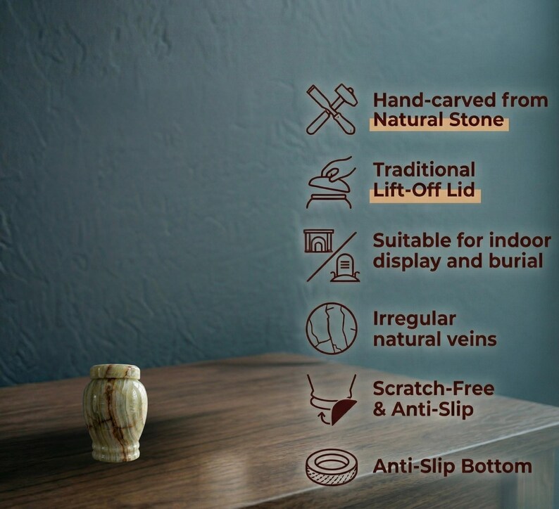 May include: A small, cylindrical stone urn with a light green and brown veined pattern and a matching lift-off lid. Text features include: Hand-carved from Natural Stone, Traditional Lift-Off Lid, Suitable for indoor display and burial, Irregular natural veins, Scratch-Free & Anti-Slip, and Anti-Slip Bottom.
