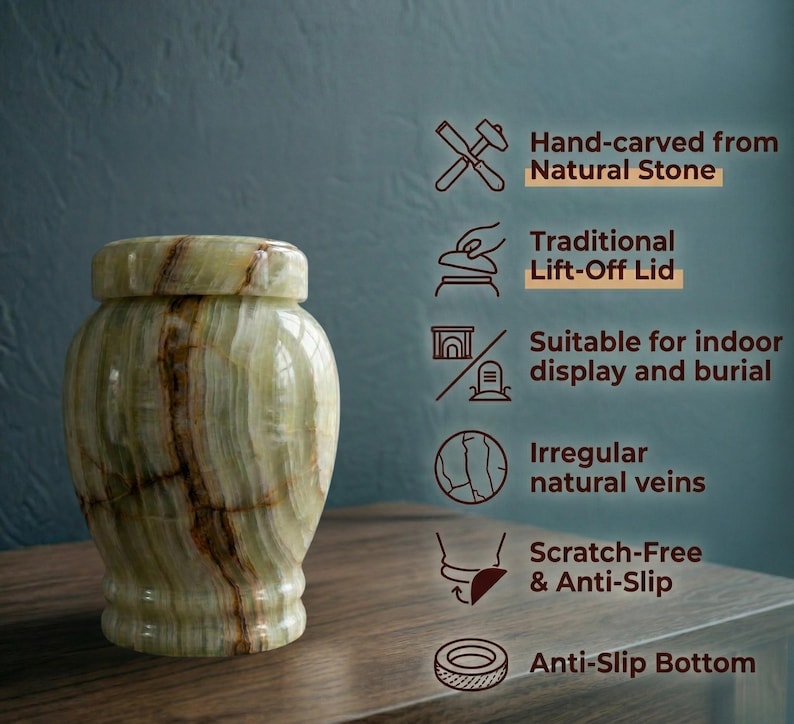 May include: A light green stone urn with brown natural veining and a lift-off lid. Text on the right lists features: Hand-carved from Natural Stone, Traditional Lift-Off Lid, Suitable for indoor display and burial, Irregular natural veins, Scratch-Free & Anti-Slip, and Anti-Slip Bottom.