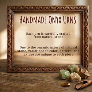 May include: A rectangular wooden frame with a carved border containing text that reads: HANDMADE ONYX URNS. Each urn is carefully crafted from natural stone. Due to the organic nature of natural stone, variations in color, pattern, and texture are unique.