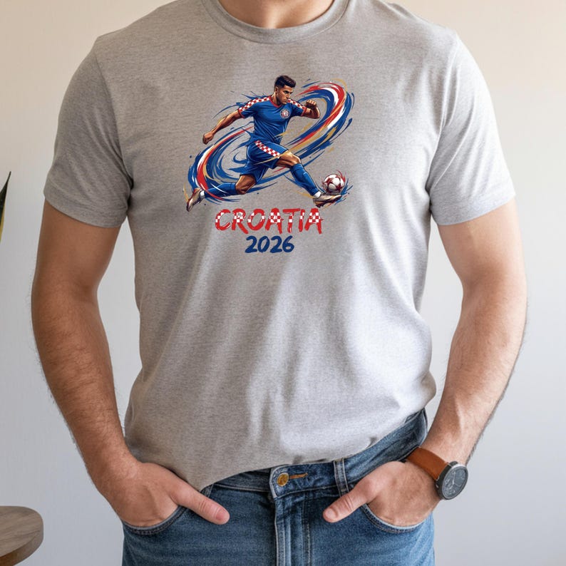 A man wearing a gray t-shirt with a graphic of a soccer player and the text "Cromia 2016" printed on it.