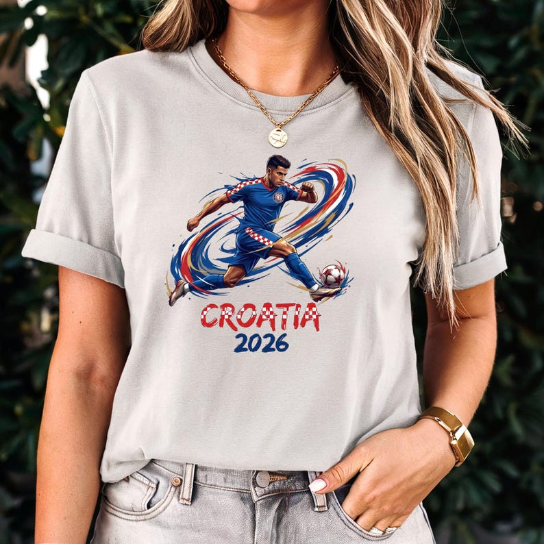 A woman wearing a white t-shirt with a graphic of a soccer player and the text "Croatia 2026" printed on it.