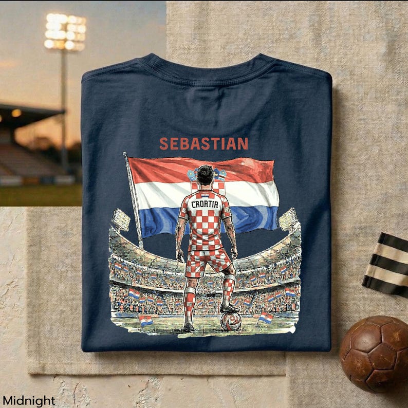 A t-shirt design featuring a soccer player standing in front of a stadium with a large flag, with the text "SEBASTIAN" and "CROATIA" printed on it.