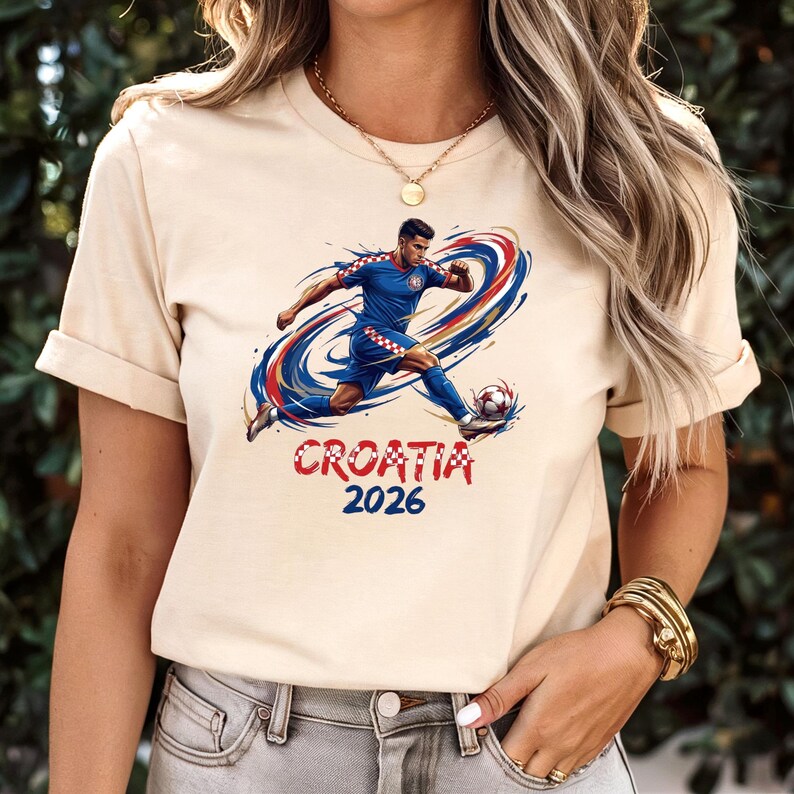 A woman wearing a white t-shirt with a graphic of a soccer player and the text "Croatia 2026" printed on it.