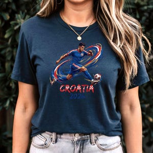 A woman wearing a dark blue t-shirt with a graphic of a soccer player and the text "Croatia 2020" printed on it.