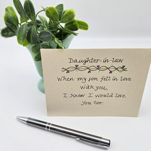 May include: A card with a handwritten message that reads "Daughter-in-law When my son fell in love With you, I knew I would love You too."