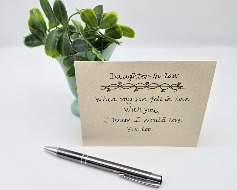May include: A card with a handwritten message that reads "Daughter-in-law When my son fell in love With you, I knew I would love You too."