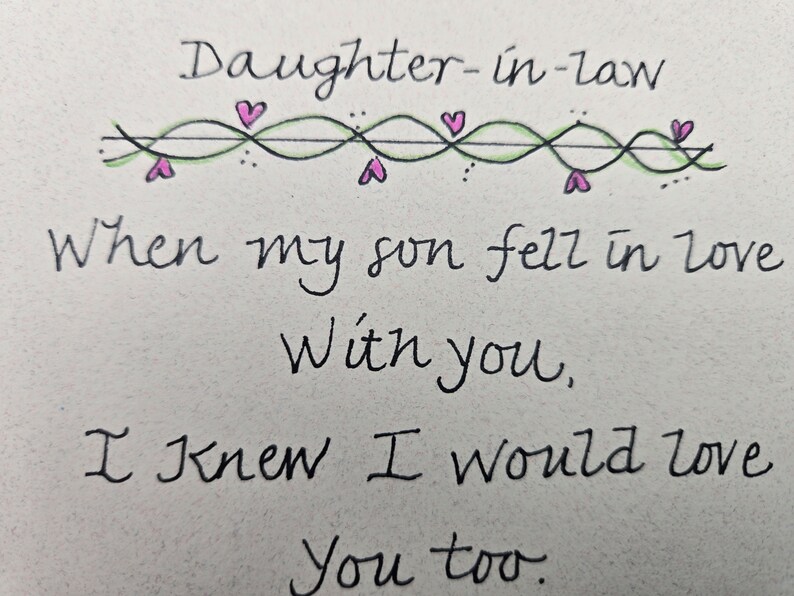 May include: Handwritten card with a decorative border of hearts and vines. The card reads "Daughter-in-law When my son fell in love With you, I knew I would love You too."