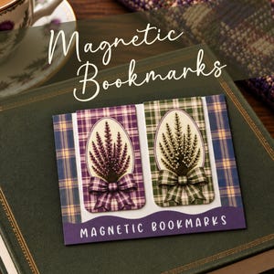 May include: Two rectangular magnetic bookmarks featuring a plaid pattern and a central oval illustration of heather flowers with a matching bow. One bookmark is purple and the other is green. The product packaging displays the text Magnetic Bookmarks.