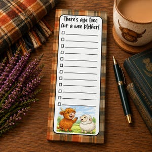 May include: A rectangular notepad with a brown and orange plaid border. The white centre features the text 'There's aye time fur a wee blether!' above a checklist of twelve lines. At the bottom, a cartoon highland cow and a white sheep are illustrated.