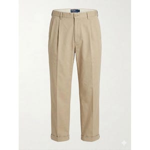 May include: Beige pleated trousers with turned-up cuffs. These smart casual trousers feature a button and zip fastening. The fabric looks like a durable cotton blend, suitable for various occasions. The trousers are presented against a plain white backdrop.