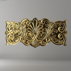 May include: A gold-colored, ornate decorative element with a symmetrical design. The piece features intricate floral and scrollwork patterns, creating a classic, elegant aesthetic. The item is likely a decorative architectural detail or furniture accent.