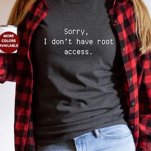 May include: A dark gray t-shirt with the text "Sorry, I don't have root access." printed in white. The person wearing the shirt is holding a white enamel mug with the text "More Colors Available" printed in red.