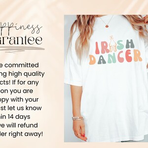 May include: White t-shirt with a colorful graphic that says "Irish Dancer". The shirt is oversized and has a relaxed fit.