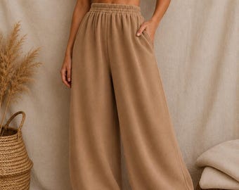 Pantalones de manta de algodón corte harem con cintura elástica y bolsillos color beige. Pantalones de pierna ancha minimalistas de manta.