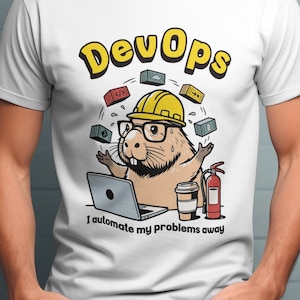 May include: White t-shirt with a cartoon beaver wearing glasses and a yellow hard hat, with the word "DevOps" above. The beaver is surrounded by small boxes and a laptop, with the text "I automate my problems away".