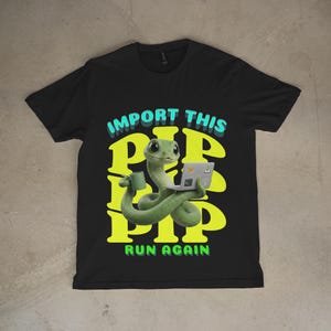 May include: Black t-shirt with a cartoon green snake using a laptop and holding a mug. The shirt displays the text "IMPORT THIS PIP PIP PIP RUN AGAIN" in a fun font. The design incorporates green, yellow, and blue colours.